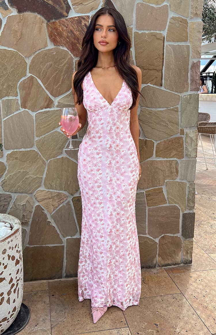 A pink floral maxi dress styled for a special occasion
